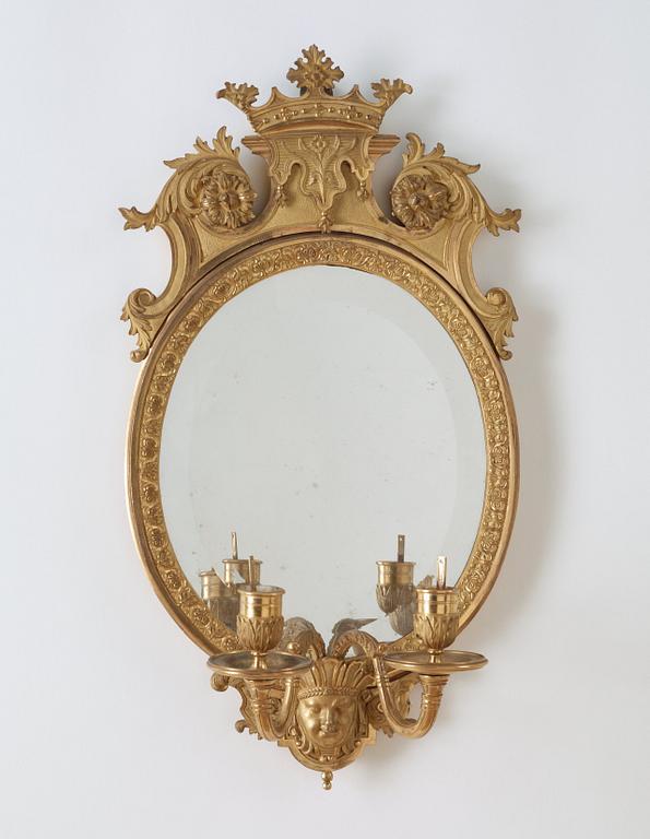 A pair of late Baroque-style circa 1900 gilt bronze two-light girandole mirrors.