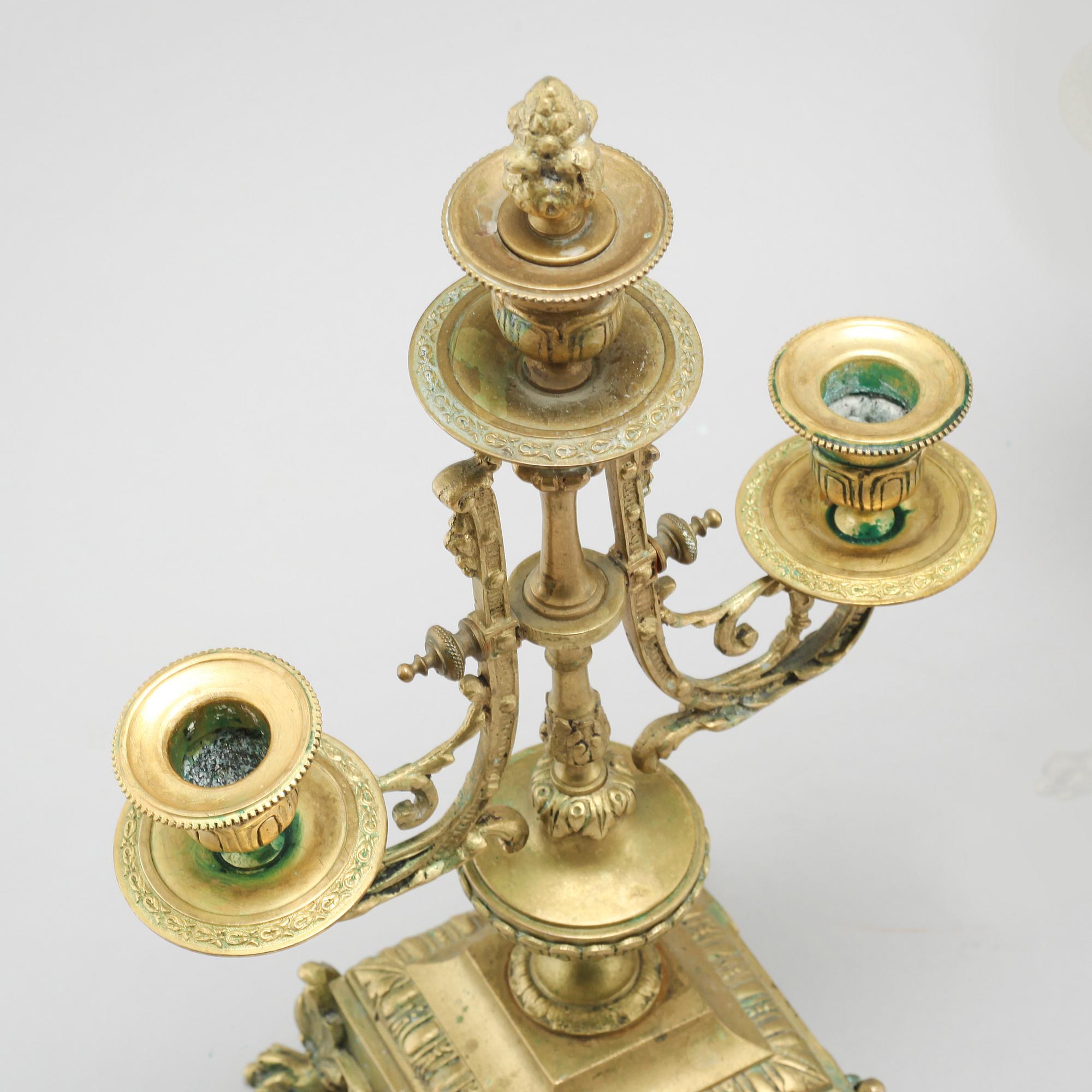 A table clock and two candelabras, around the year 1900.