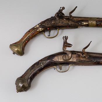 Two 19th century flintlock pistols.