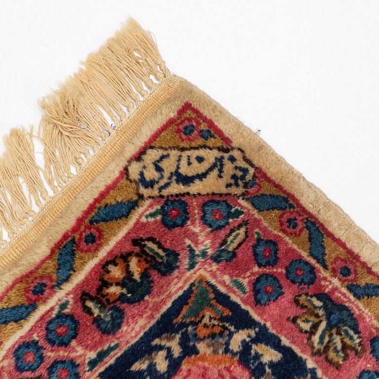 An carpet, possibly Kirman, signed, 350 x 255 cm.