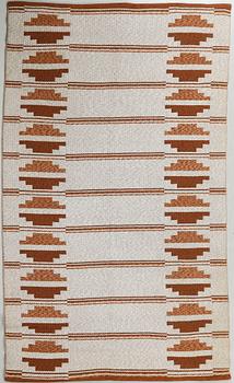 A flat weave carpet from around the middle of the 20th century.