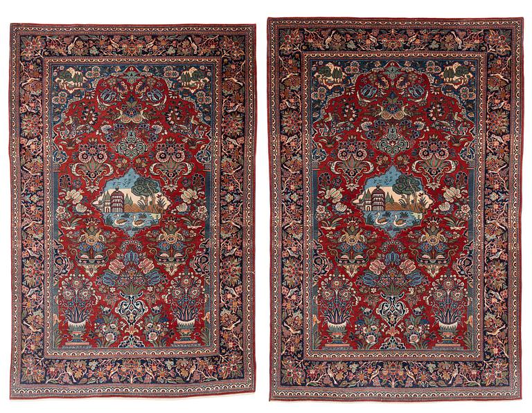 A pair of semi-antique pictoral Kashan rugs, ca 200 x 130 and 197 x 128 cm.