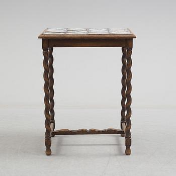 A 20th century Baroque-style table with tiles.