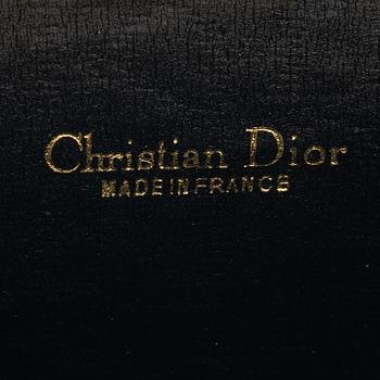 Christian Dior, a canvas clutch and wallet.