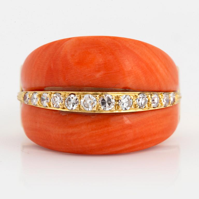 An 18K gold and coral ring set with eight-cut diamonds.