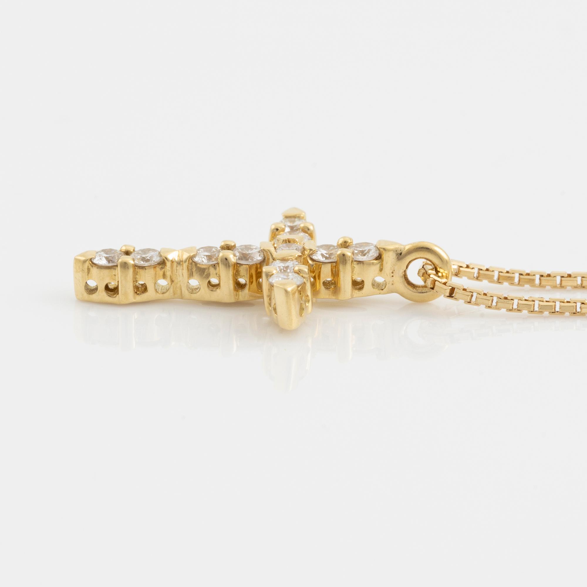 A pendant/cross 18K gold with round brilliant-cut diamonds.