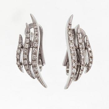 A pair of 18K white gold earrings and a ring with diamonds ca. 0.90 ct in total. Moscow.