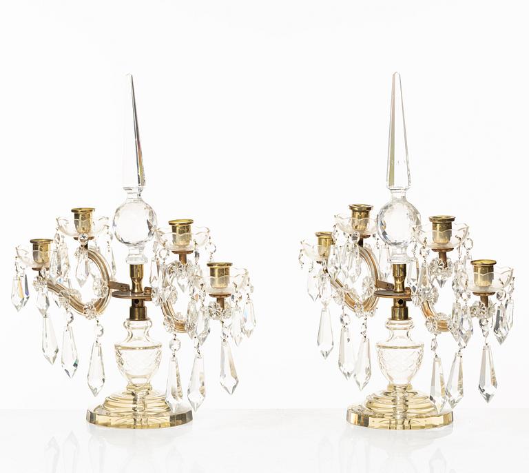 A pair of brass and glass canelabras, first half of the 20th century.