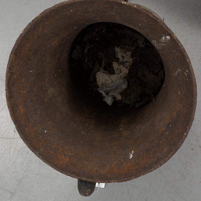 A cast iron green garden urn, dated 1791.