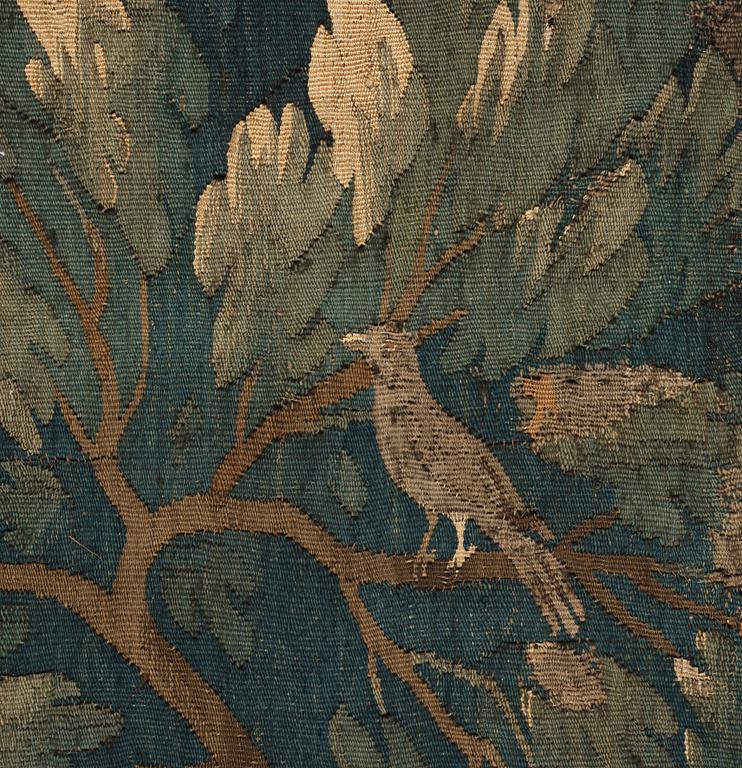 A TAPESTRY, tapestry weave, a "Verdure",  ca 304 x 224,5 cm, Flanders 17th century, signed "W" a lily "B".