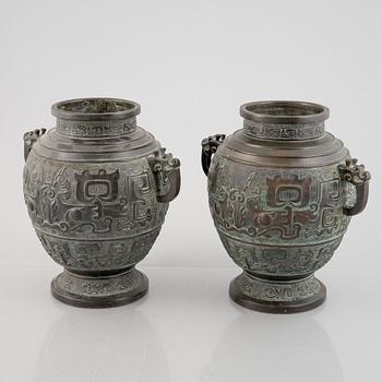 A pair of Chinese bronze urns, 20th century.