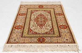 A Hereke silk rug, West Anatolia, c. 107 x 69 cm.