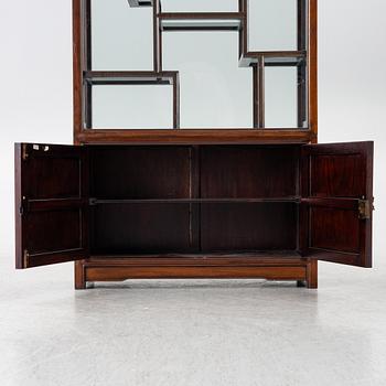 A Chinese display cabinet, wood and glass, later part of the 20th century.