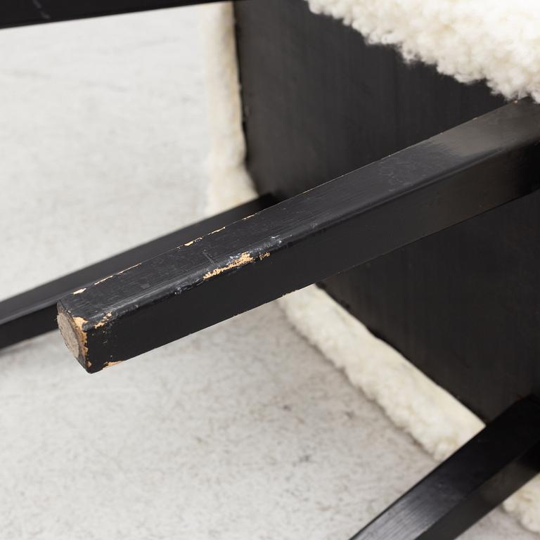 A mid 20th Century stool with sheepskin upholstery.