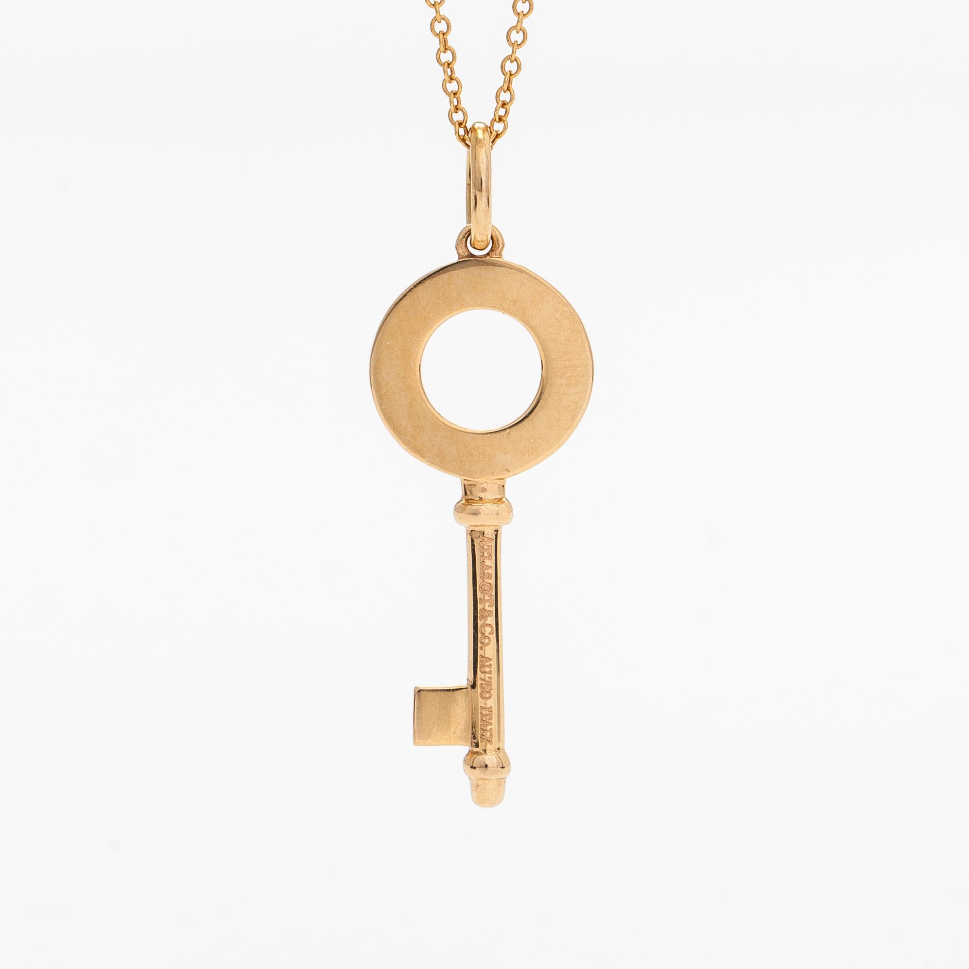 Tiffany & Co, an 18K gold 'Atlas Key' pendant with chain.