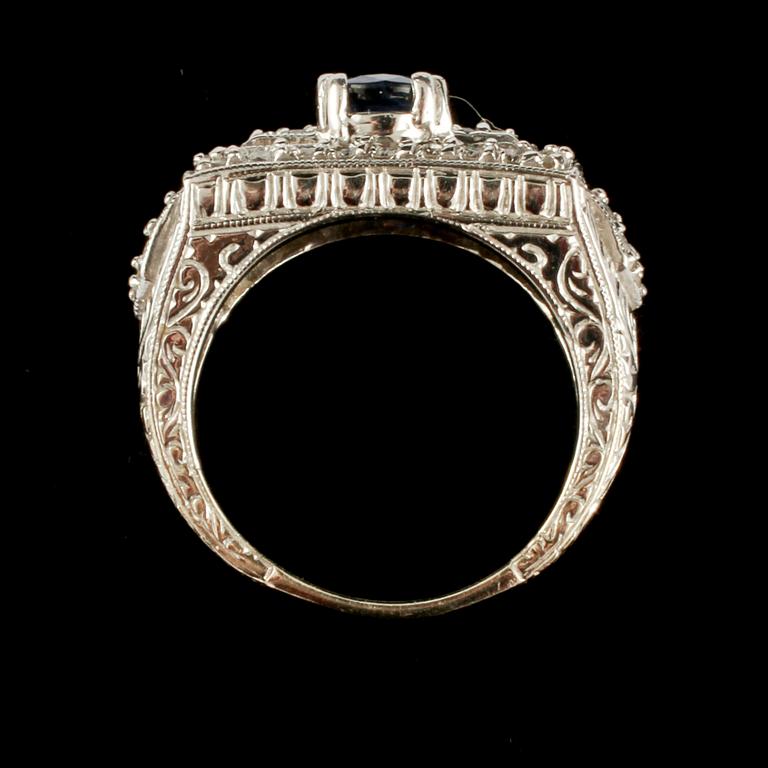 RING, 14k vitguld med små briljantslipade diamanter samt fasettslipad blå safir, utländska stämplar. Vikt 8 g.