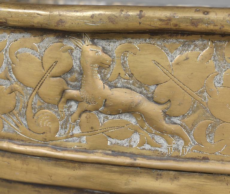 A Baroque brass wine cooler.
