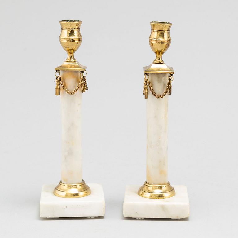 A 20th Century pair of Gustavian style candle sticks.