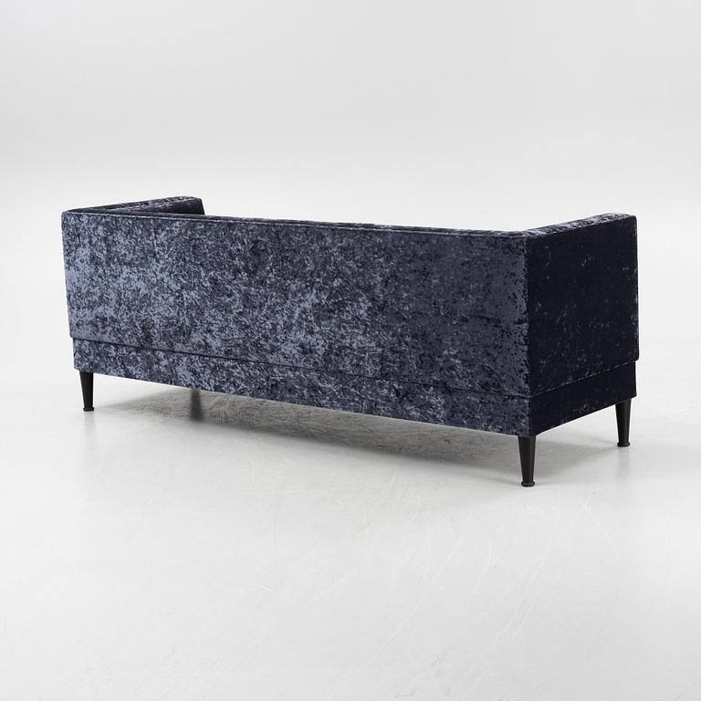 A contemporary velvet sofa by Shaun Clarkson.