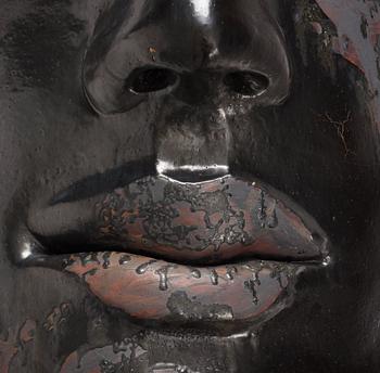 Hertha Hillfon, a black glazed stoneware wall sculpture in two parts of a face and a sky, executed in her own studio, Stockholm 1960s.