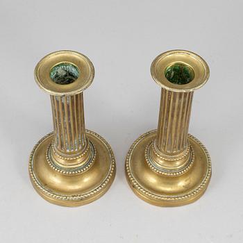 A pair of Louis Seize bronze candlesticks.