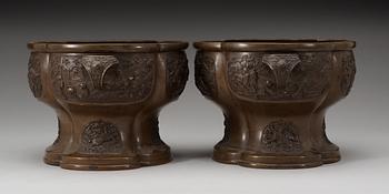 A pair of lobed bronze flower pots, Qing dynasty, with Xuandes six character mark to the interior.