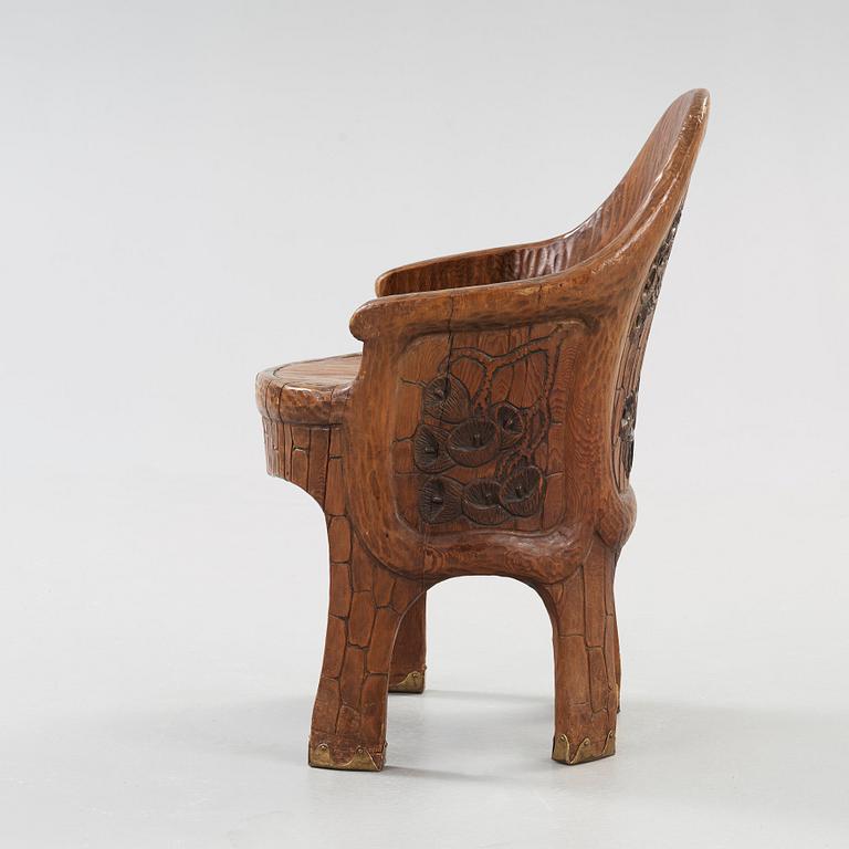 A Gustaf Fjaestad Art Nouveau carved pine chair 'Stabbestol', executed by Adolf Swanson, Arvika, Sweden 1908.