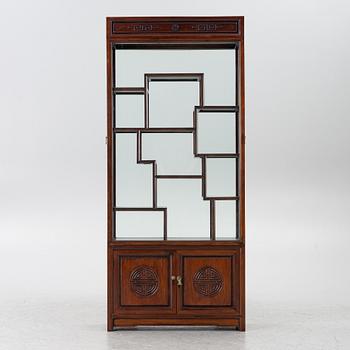 A Chinese display cabinet, wood and glass, later part of the 20th century.