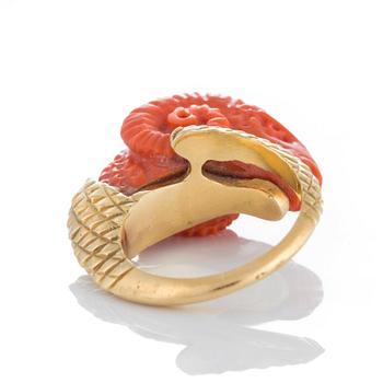 A ring in carved coral in the form of a ram's head.