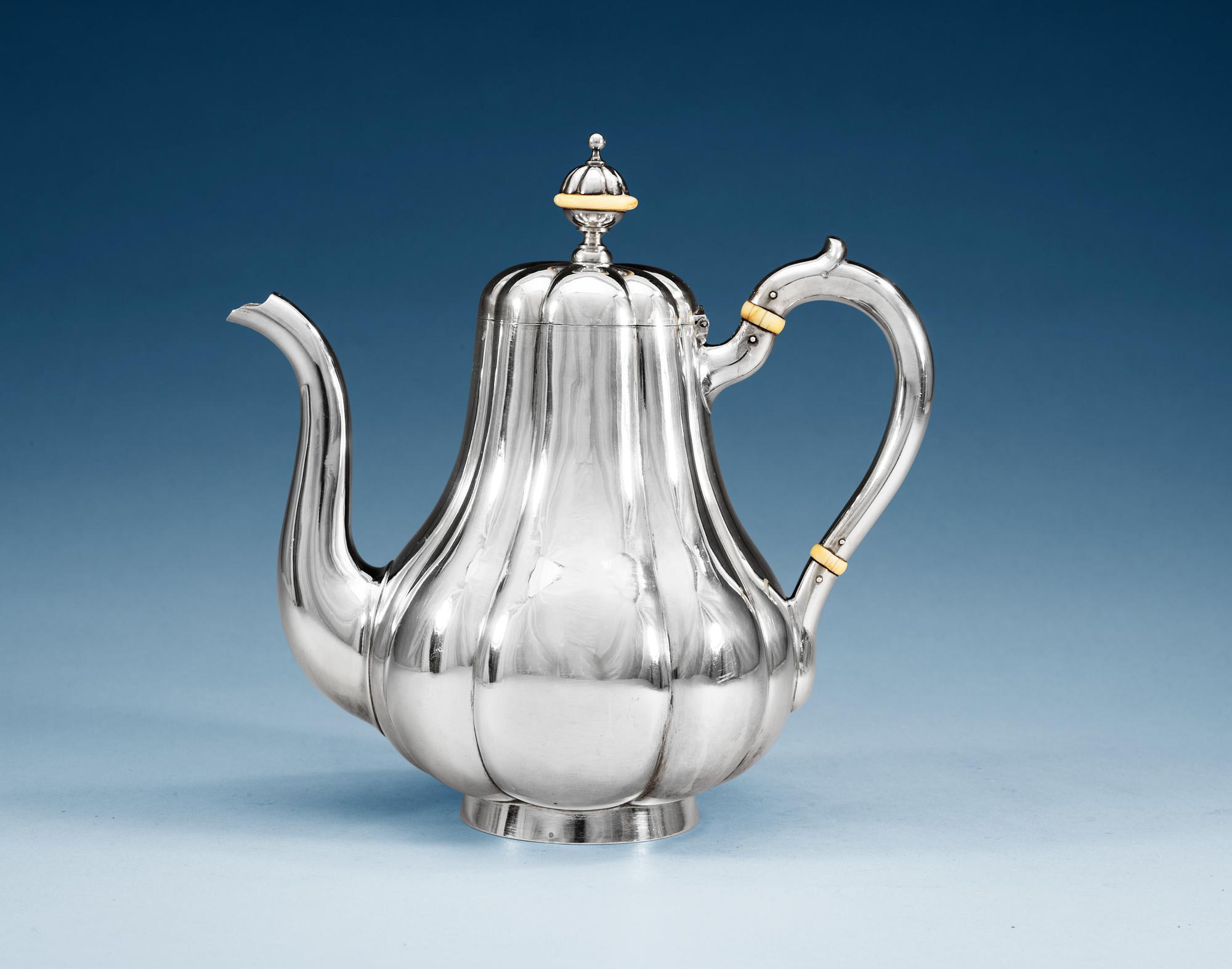 A RUSSIAN PARCEL-GILT COFFEE-POT, Makers mark of Nicholai Kemper, St. Petersburg 1893.