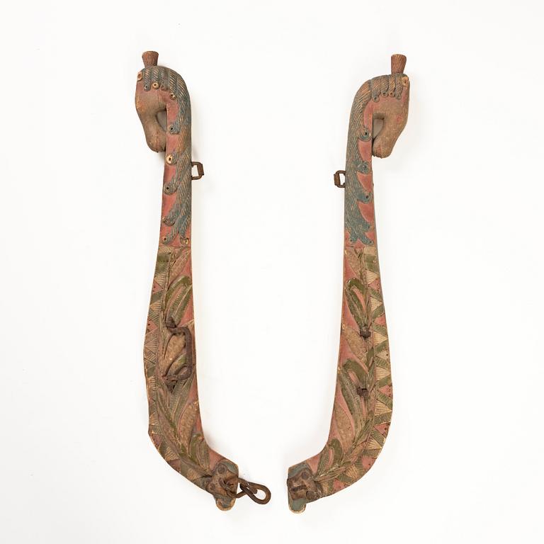 A pair of Swedish carved and painted horse harness parts, 18th century.
