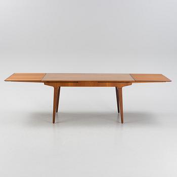A 1960s teak veneer dining table.