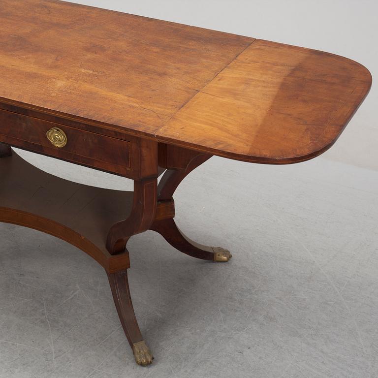 An Empire style mahogany  center table from around the year 1900.
