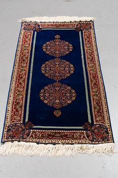 A rug, silk Hereke, ca 143 x 63,5 cm.