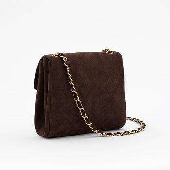 CHANEL, a brown suede shoulderpurse.
