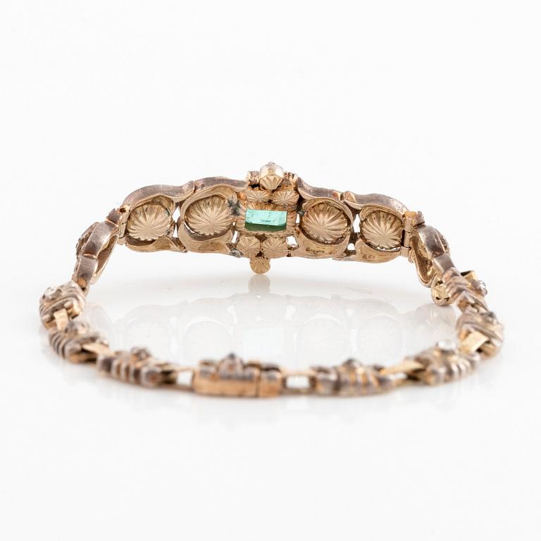 A 14K gold and silver bracelet set with an emerald and rose-cut diamonds.