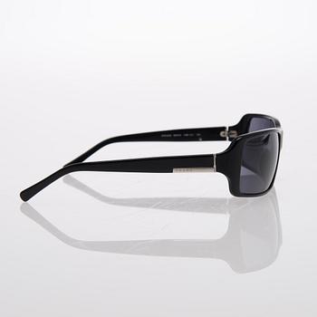 Two Pairs of Sunglasses, Prada and Chanel.