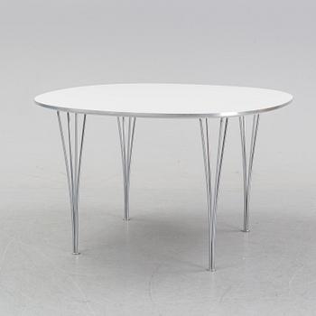A 'Supercircular' table by Bruno Mathsson & Piet Hein for Fritz Hansen, dated 1985.