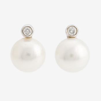 A pair of 18K gold earrings with cultured pearls and round brilliant-cut diamonds.