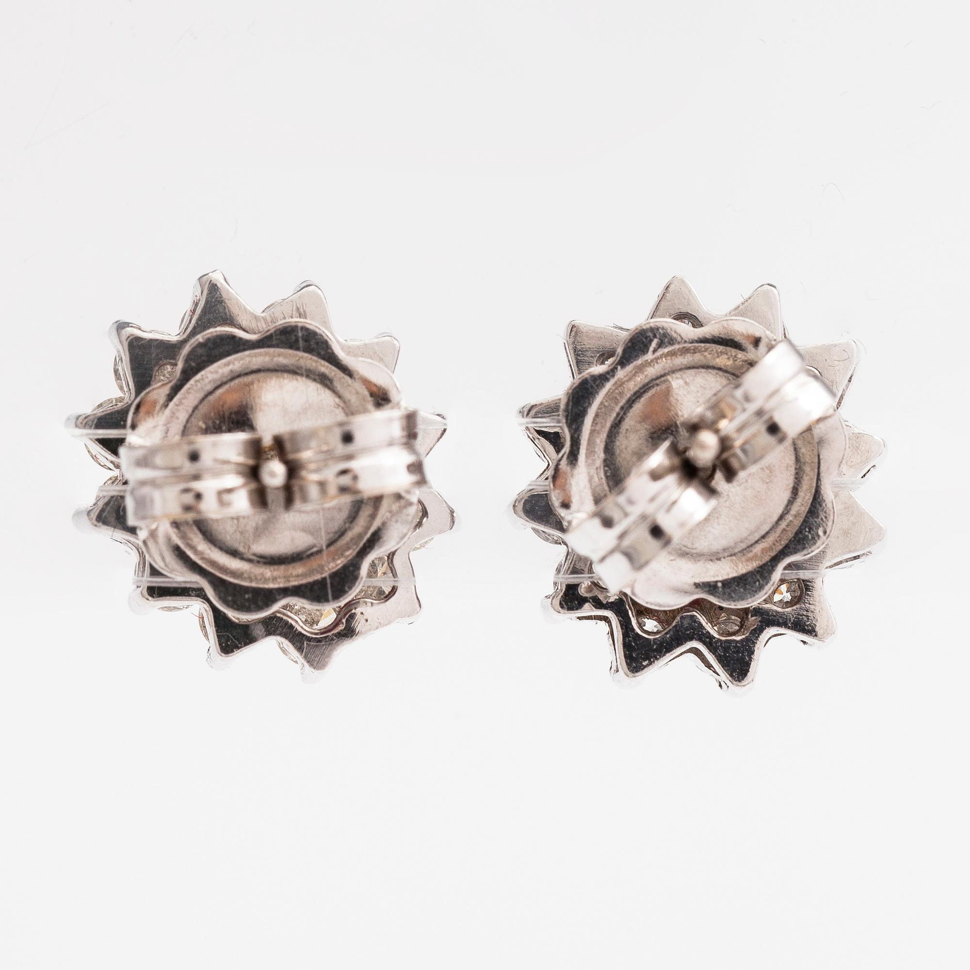 A pair of 18K white gold earrings with brilliant cut diamonds ca. 0.96 ct in total and rubies. Rubens, Helsinki.