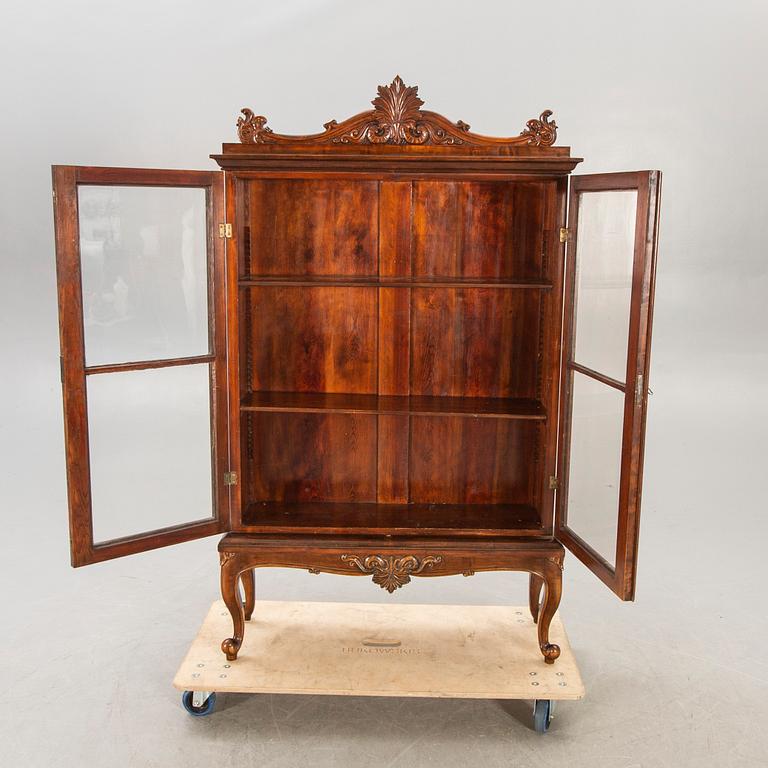 A 1940s Rococo style display cabinet.