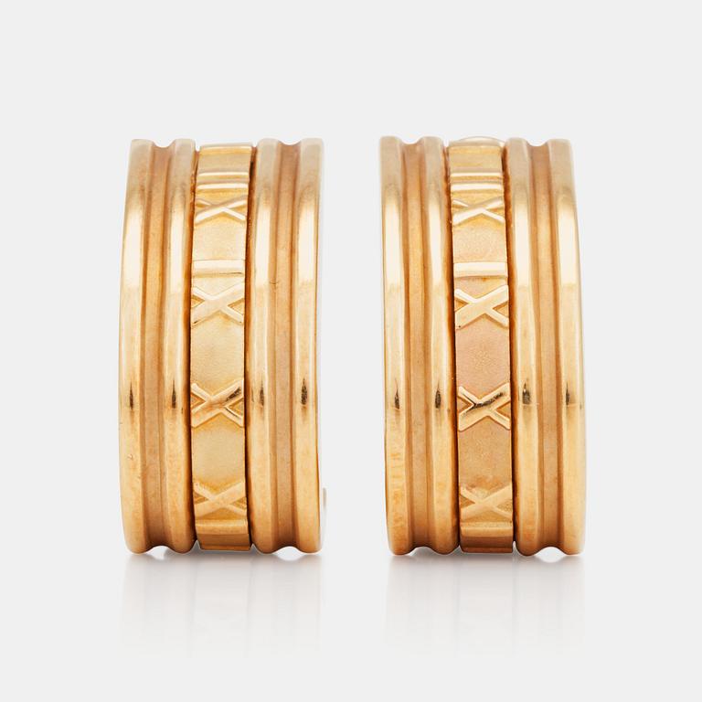 A pair of Tiffany & co gold earrings.