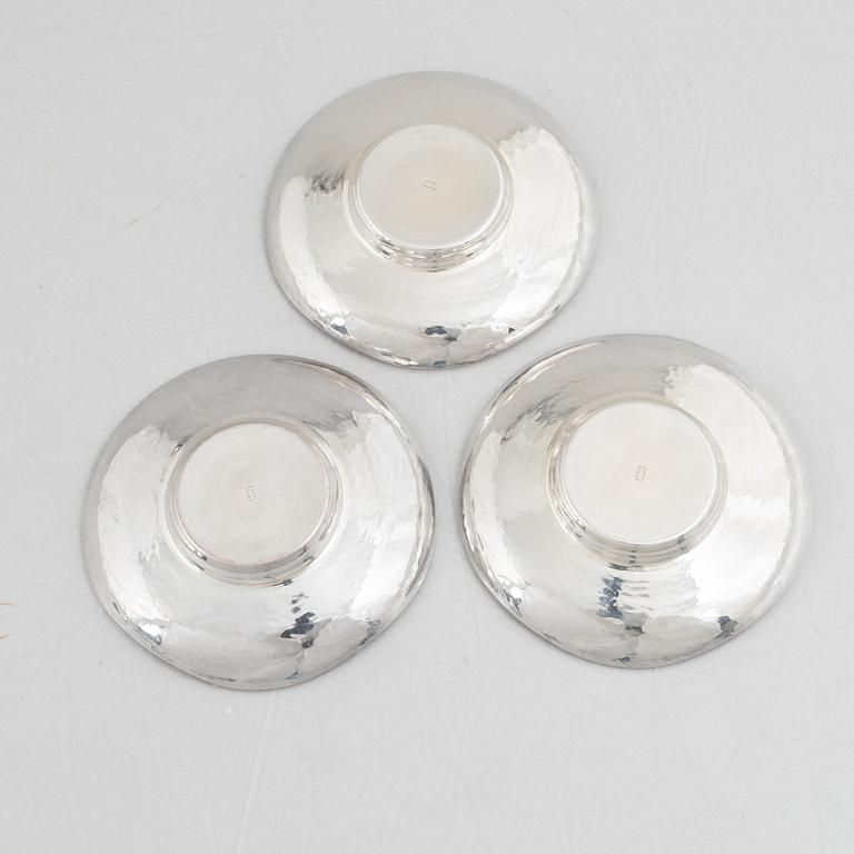 A set of three Japanese silver coasters and a pair of salts with shakers, 20th century.