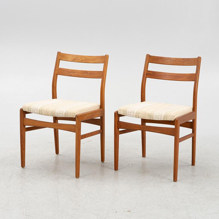 A dining table with six chairs, mid 20th century.