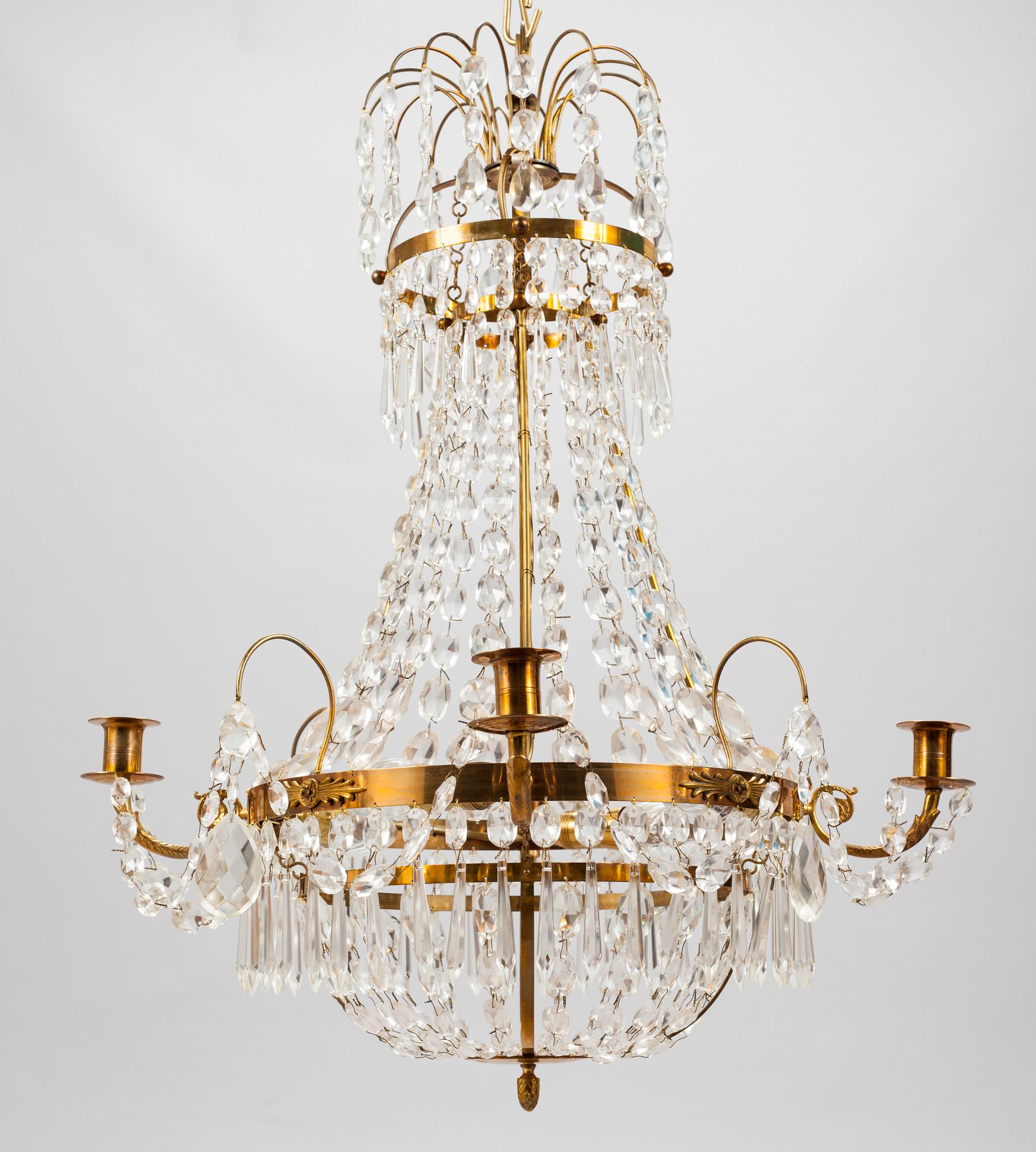 A Gustavian style chandelier from the first half of the 20th century. Height 67 cm.