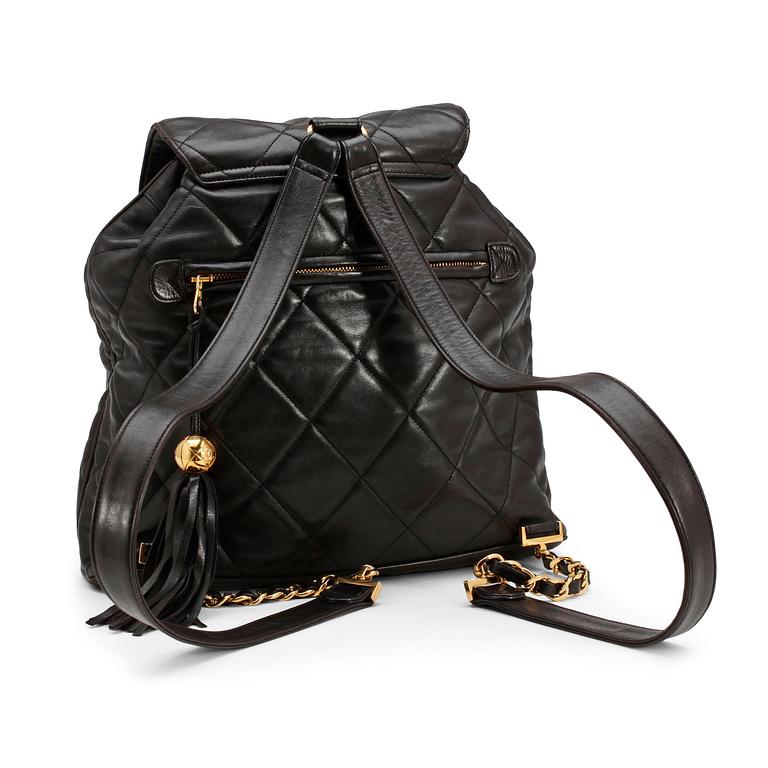 CHANEL, a black leather quilted backpack.