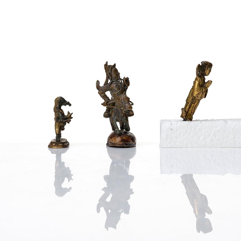 A group of three bronze miniatures sculptures of deities, China and Tibet, 18th Century.