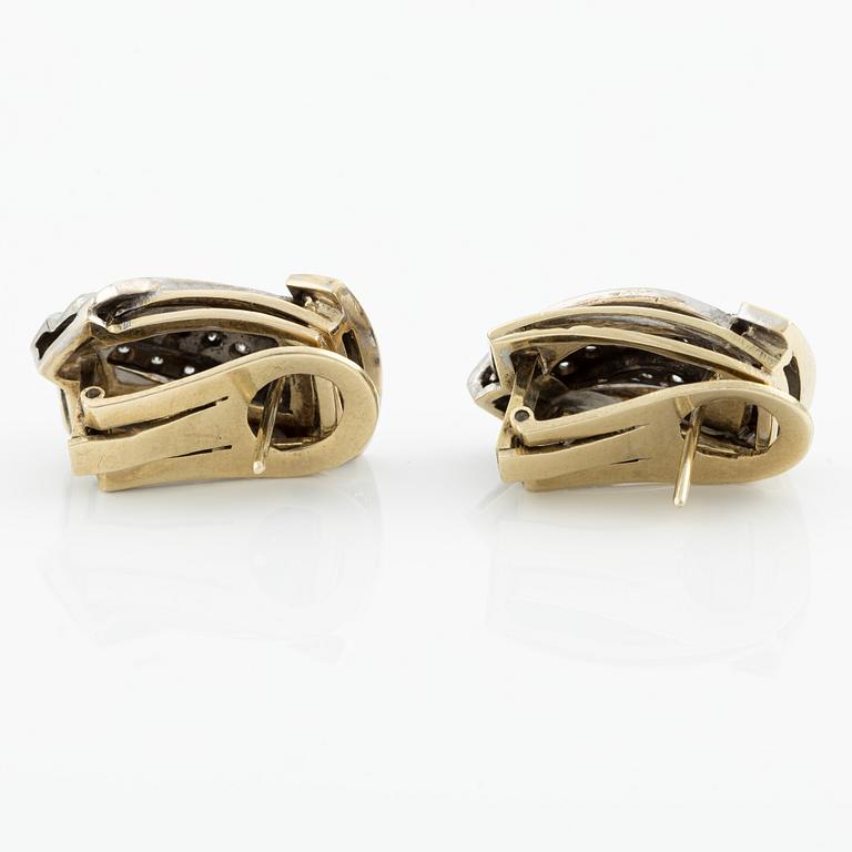 Gold earrings with brilliant-cut and octagon-cut diamonds.