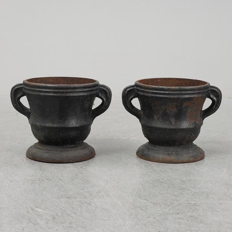 A 19th  century pair of cast iron flower pots.