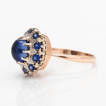 A 14K gold ring with a cabochon-cut synthetic sapphire and real sapphires. Yerevan.